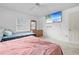 Bright bedroom featuring two beds, neutral carpet, a ceiling fan, and a wall-mounted television at 9069 Gaynor St, Spring Hill, FL 34608