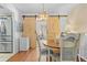 Charming dining area featuring sliding barn doors, modern light fixture, and warm wood floors at 9069 Gaynor St, Spring Hill, FL 34608