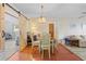 Cozy dining room featuring a rustic light fixture, wood floors, and a charming barn door at 9069 Gaynor St, Spring Hill, FL 34608