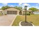 Charming single-story home featuring a well-manicured lawn, decorative stone accents, and a spacious driveway at 9069 Gaynor St, Spring Hill, FL 34608