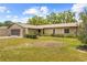 Ranch style home with stone siding, groomed landscaping and a screened garage at 9069 Gaynor St, Spring Hill, FL 34608