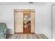 Hallway with wood-look flooring and a view into the dining room through the barn doors at 9069 Gaynor St, Spring Hill, FL 34608