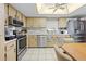 Kitchen features stainless steel appliances, including a gas range and refrigerator at 9069 Gaynor St, Spring Hill, FL 34608