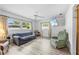 Bright living room with large windows, ceiling fan, and modern flooring at 9069 Gaynor St, Spring Hill, FL 34608