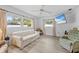 Bright living room featuring wood-look flooring, large windows and comfortable seating at 9069 Gaynor St, Spring Hill, FL 34608
