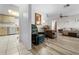 Open-concept living room flowing to the kitchen, complete with comfortable furniture at 9069 Gaynor St, Spring Hill, FL 34608