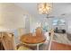 Comfortable living area with wood floors, connecting to the dining room and featuring a flat-screen TV at 9069 Gaynor St, Spring Hill, FL 34608