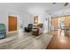 Spacious living room with wood-look flooring and comfortable seating, perfect for relaxation at 9069 Gaynor St, Spring Hill, FL 34608
