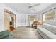 Open-concept living room featuring sliding barn doors, neutral paint, and new flooring at 9069 Gaynor St, Spring Hill, FL 34608