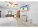 Comfortable main bedroom with ceiling fan, large television, and neutral decor at 9069 Gaynor St, Spring Hill, FL 34608