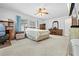 Bright main bedroom with large window, ceiling fan, and hardwood furniture at 9069 Gaynor St, Spring Hill, FL 34608