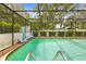 Sparkling screened-in pool with clear water offers the perfect backyard retreat at 9069 Gaynor St, Spring Hill, FL 34608