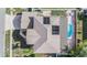 Aerial view of a home with a pool, solar panels, and lush landscaping enhancing the property's appeal at 10003 Vista Pointe Dr, Tampa, FL 33635