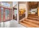 Beautiful foyer featuring staircase, decorative front door, and adjacent formal dining area at 10003 Vista Pointe Dr, Tampa, FL 33635