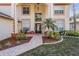 Inviting front entrance showcasing a well-manicured lawn and a decorative walkway leading to the front door at 10003 Vista Pointe Dr, Tampa, FL 33635