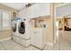 Well-equipped laundry room featuring a washer, dryer, utility sink, and ample storage cabinets at 10003 Vista Pointe Dr, Tampa, FL 33635
