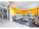 Bright living room with a gray rug, contemporary furniture, and vibrant yellow walls and stylish decor at 10003 Vista Pointe Dr, Tampa, FL 33635