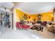 Bright living room featuring tile floors, yellow accent wall, and decorative furniture at 10003 Vista Pointe Dr, Tampa, FL 33635