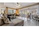 Bright living room featuring plantation shutters, neutral tones and comfortable seating at 10003 Vista Pointe Dr, Tampa, FL 33635