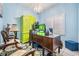 Bright office featuring blue walls, shuttered window, unique light fixture, and colorful accent pieces at 10003 Vista Pointe Dr, Tampa, FL 33635