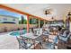 Beautiful covered patio area, perfect for outdoor dining and relaxation, overlooking a sparkling pool at 10003 Vista Pointe Dr, Tampa, FL 33635
