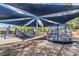 Community playground featuring modern equipment under a shaded canopy, designed for outdoor fun and recreation at 10003 Vista Pointe Dr, Tampa, FL 33635