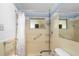 Bathroom shower with seat, handrails, and convenient shelving at 10155 36Th N Way, Pinellas Park, FL 33782
