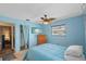 Blue bedroom featuring a ceiling fan, closet, and TV at 10155 36Th N Way, Pinellas Park, FL 33782