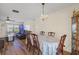 Charming dining area with a chandelier, table set for six, and seamless access to living room at 10155 36Th N Way, Pinellas Park, FL 33782