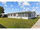 A one-story home with a screen-enclosed lanai and a well-manicured lawn at 10155 36Th N Way, Pinellas Park, FL 33782