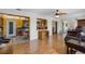 Open-concept living space with hardwood floors and bright, connecting kitchen view at 10155 36Th N Way, Pinellas Park, FL 33782