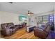 Comfortable living room with laminate floors, ceiling fan, and ample seating at 10155 36Th N Way, Pinellas Park, FL 33782
