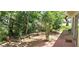Tranquil backyard with lush landscaping and a brick paver patio at 10728 Fallen Leaf Ln, Port Richey, FL 34668