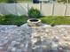 Brick paver patio featuring a stone fire pit with white rock and tropical landscaping at 11241 Temple Ct, Seminole, FL 33772