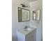 Modern bathroom vanity features updated faucet, hardware, and lighting at 11241 Temple Ct, Seminole, FL 33772