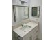 Modern bathroom vanity features updated faucet, hardware, and lighting at 11241 Temple Ct, Seminole, FL 33772