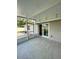 Spacious screened lanai with tile flooring and backyard access at 11241 Temple Ct, Seminole, FL 33772