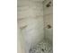 Modern shower featuring stone-patterned tile and brushed metal fixtures at 11241 Temple Ct, Seminole, FL 33772