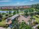 Aerial view of a neighborhood park with a playground near a pond and residential area at 11862 Frost Aster Dr, Riverview, FL 33579