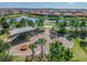 Aerial view of a playground near homes in the neighborhood, set beside a calm pond at 11862 Frost Aster Dr, Riverview, FL 33579
