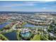Aerial view of a sprawling community with numerous homes, lush green spaces, and serene lakes at 11862 Frost Aster Dr, Riverview, FL 33579