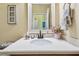 Bathroom with a white countertop, black faucet and view into hallway at 11862 Frost Aster Dr, Riverview, FL 33579