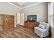 Cozy bedroom with wood floors, natural light, en suite bathroom and ample space for furniture at 11862 Frost Aster Dr, Riverview, FL 33579