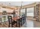 Dining room adjacent to kitchen features wood floors, chandelier, and abundant natural light at 11862 Frost Aster Dr, Riverview, FL 33579