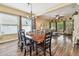 Dining room with hardwood floors, chandelier, and abundant natural light with views to Gathering room at 11862 Frost Aster Dr, Riverview, FL 33579