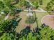Aerial view of a dog park with a concrete pad, walking paths, and a shaded grassy area at 11862 Frost Aster Dr, Riverview, FL 33579