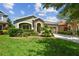 Beautiful home with a well-kept lawn, mature landscaping, and an attached garage at 11862 Frost Aster Dr, Riverview, FL 33579
