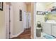 Hallway leading to laundry room featuring hardwood floors and natural light at 11862 Frost Aster Dr, Riverview, FL 33579