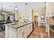 Spacious kitchen features granite counters, stainless appliances, pendant lights, and wood flooring at 11862 Frost Aster Dr, Riverview, FL 33579