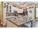 Kitchen island with granite countertop, pendant lighting, and bar stool seating at 11862 Frost Aster Dr, Riverview, FL 33579